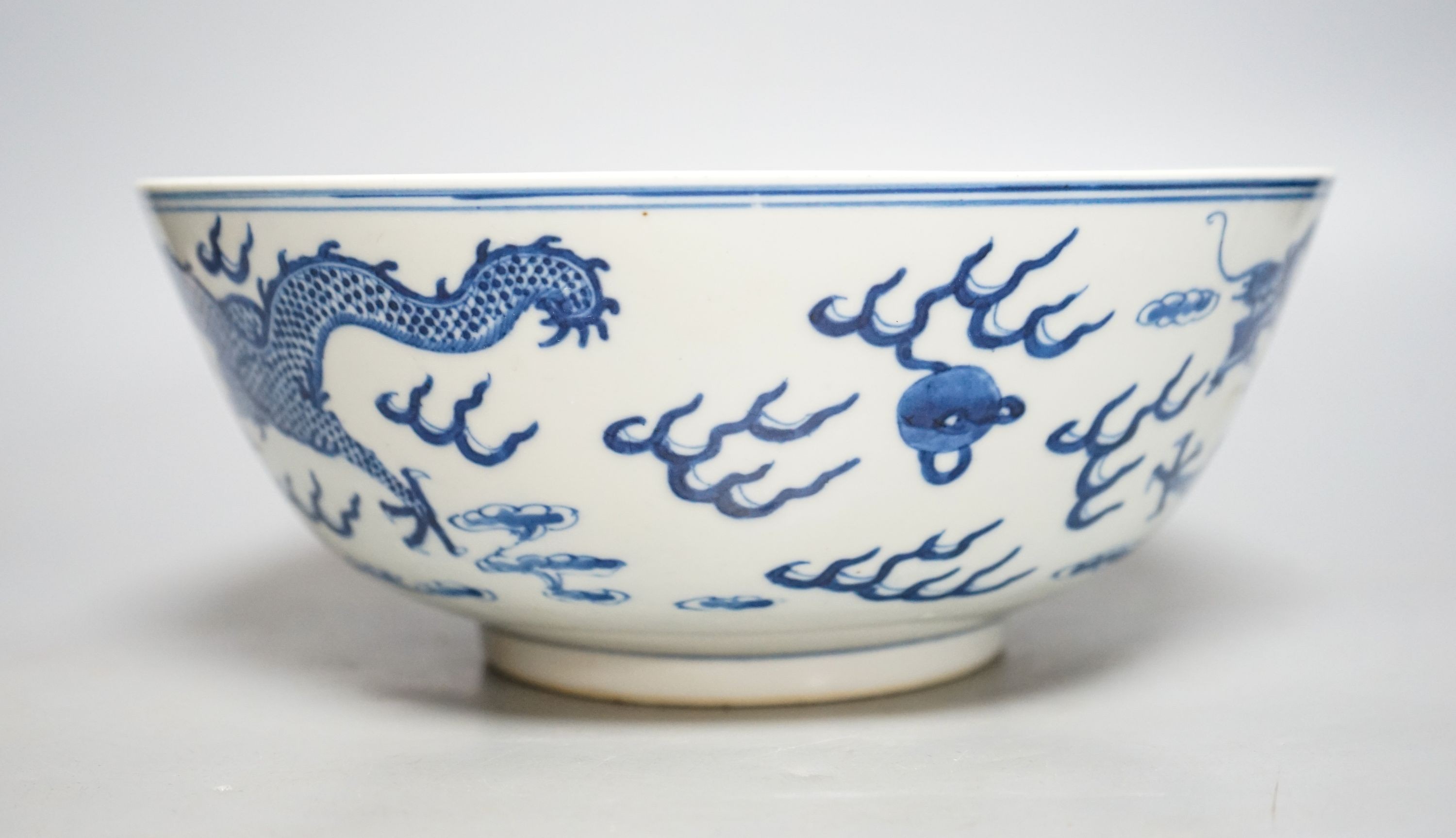 A Chinese blue and white ‘dragon’ bowl, Kangxi mark, late 19th century 25cm